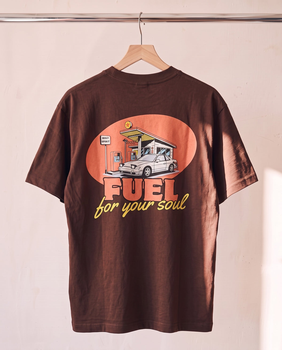 Fuel For Your Soul Christian tee in brown on a wood hanger, back print