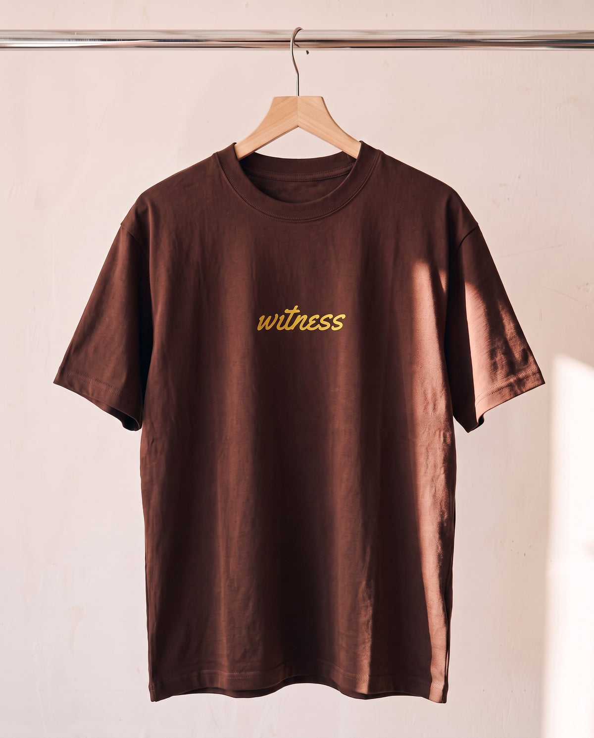 Fuel For Your Soul Christian tee in brown on a wood hanger, front